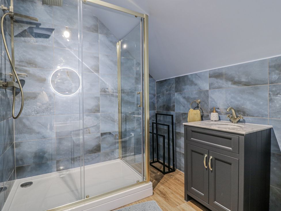 A bathroom with a shower and vanity at The Walnut Room - Windmill Country Retreats, Wymondham near Buckminster
