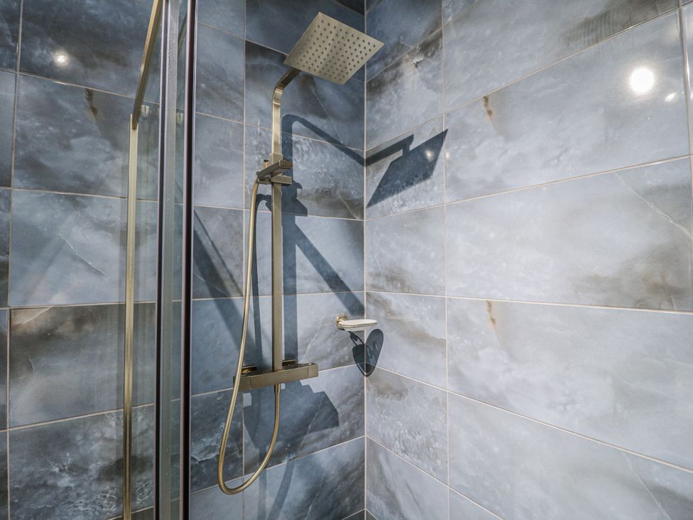 A shower area with tiles and shower features at The Walnut Room - Windmill Country Retreats Wymondham near Buckminster