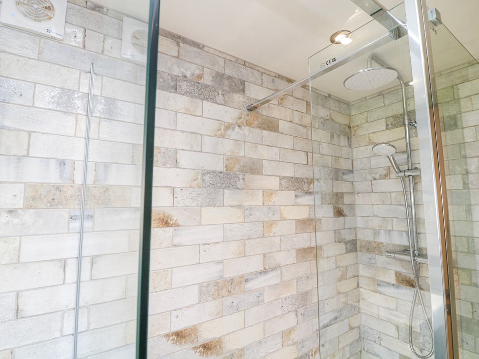 A shower with glass panel and tiled walls at Frog Leap in Scunthorpe