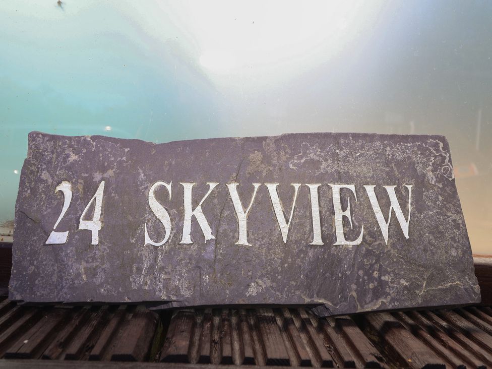 A slate sign with the number 24 and the text Skyview
