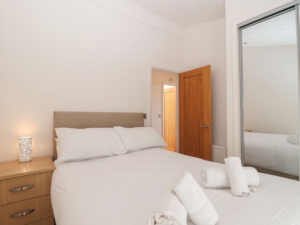 A bedroom with a bed and bedside table at Skyview in Newton Ferrers
