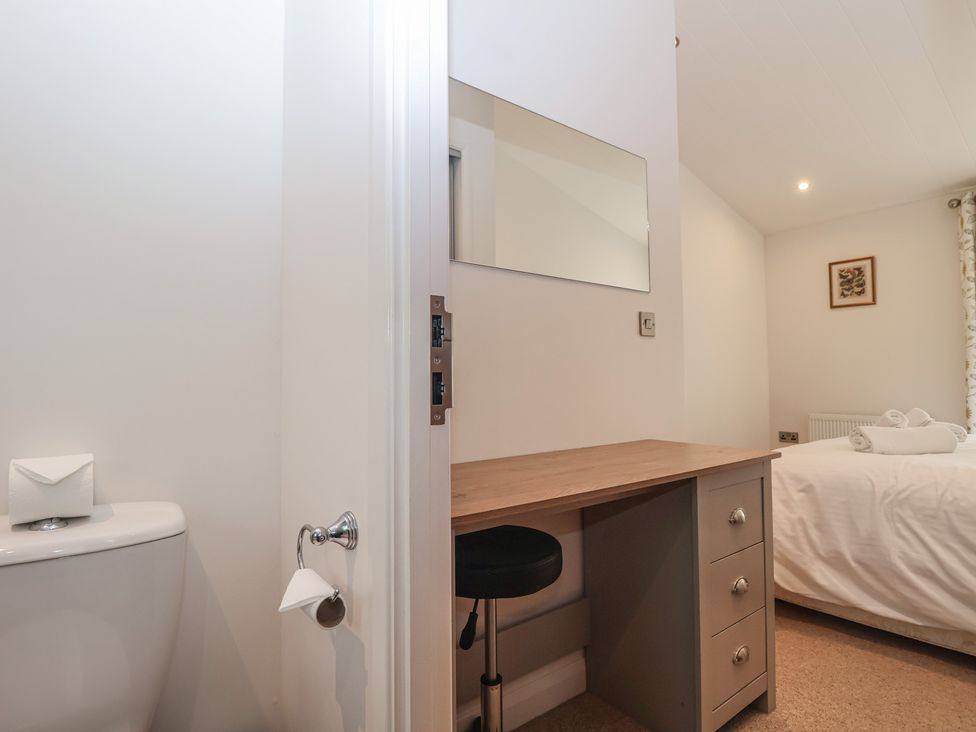 A bedroom with a desk and a bed at Skyview in Newton Ferrers