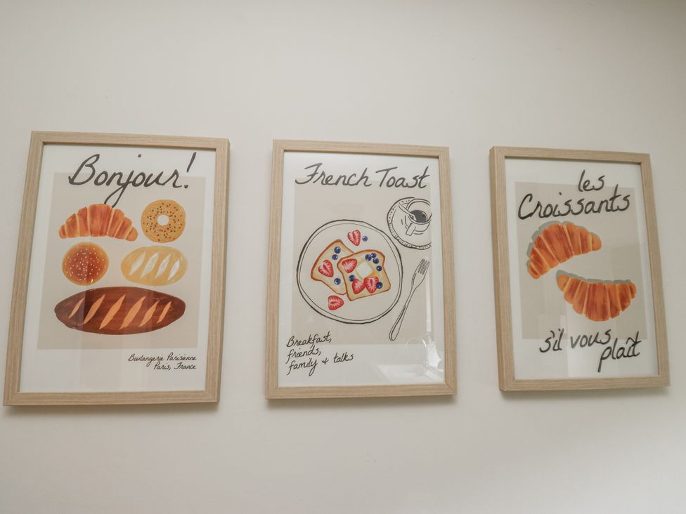 Framed illustrations of baked goods and breakfast items at Court Street Cottage Uppermill