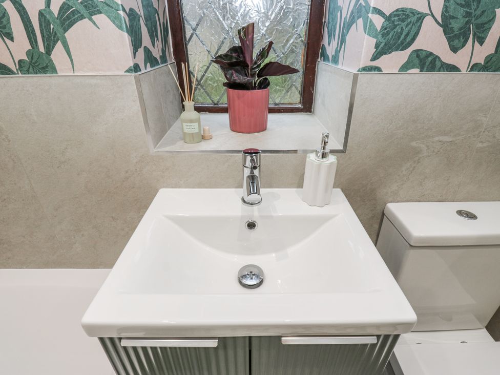 A bathroom with a sink and toilet at Court Street Cottage Uppermill