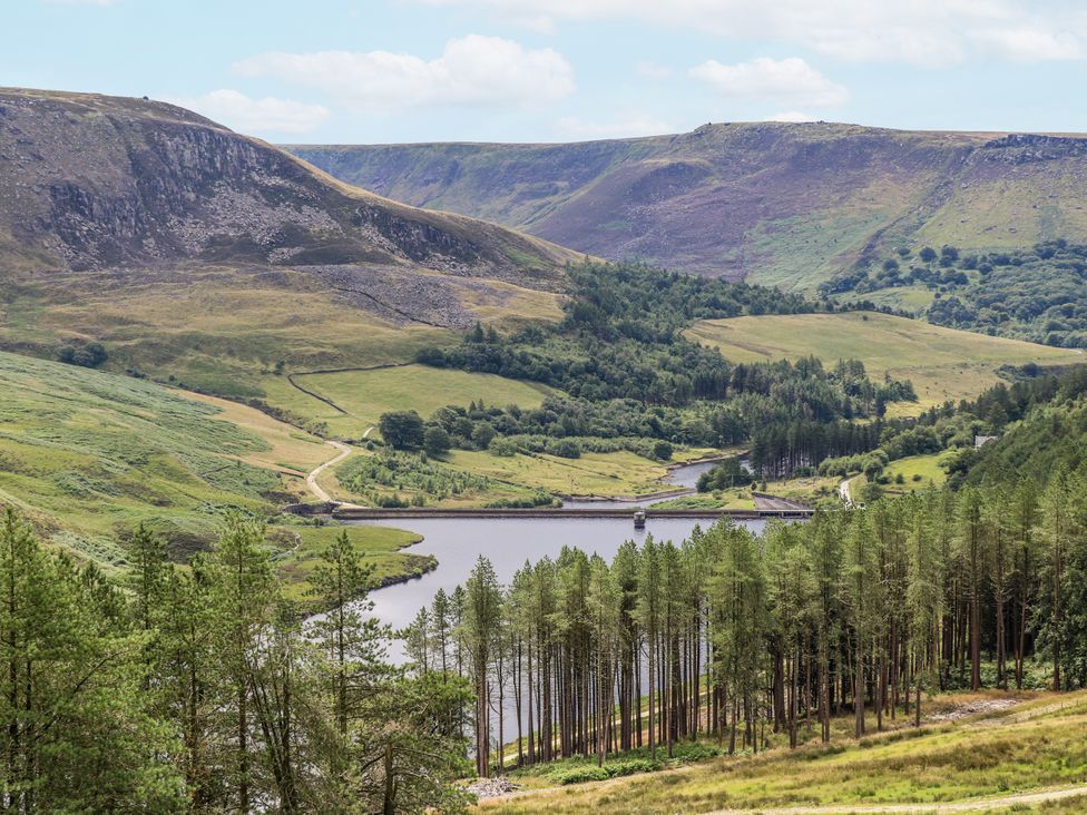 A landscape view featuring mountains, a lake, and trees at Court Street Cottage in Uppermill