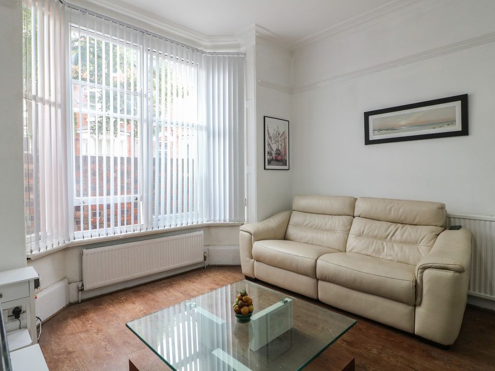 A living room with a sofa and coffee table at 2 Evington Road