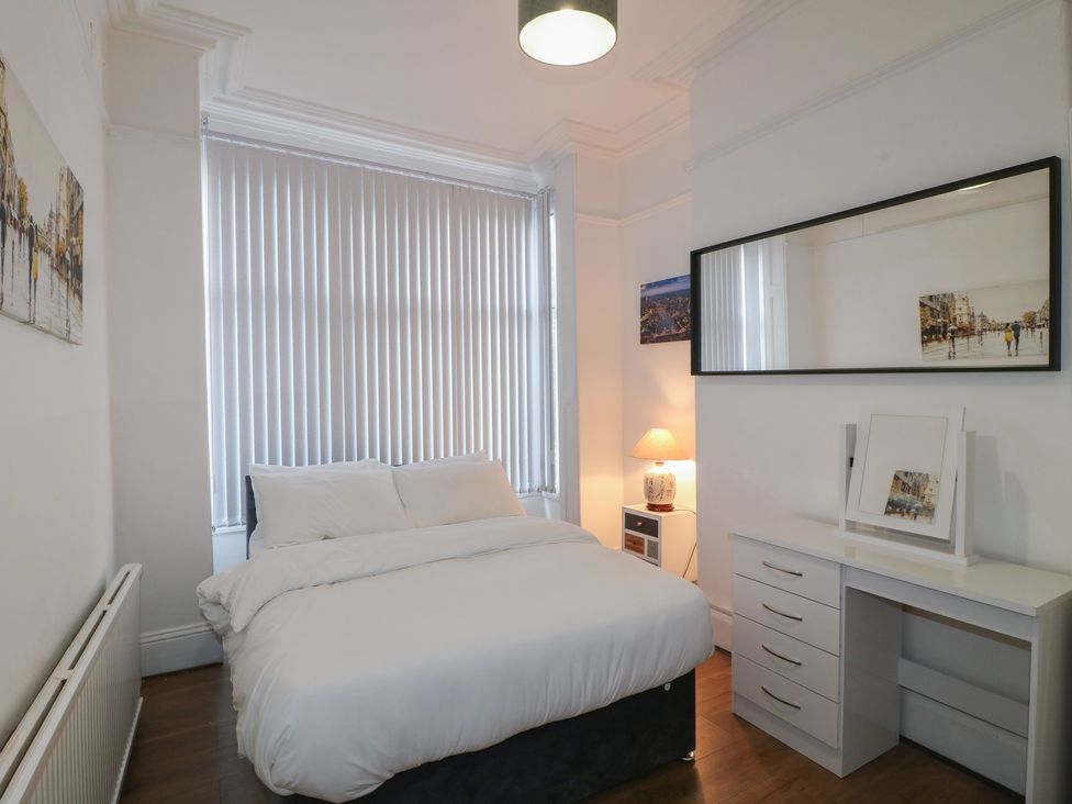 A bedroom with a bed and desk at 2 Evington Road