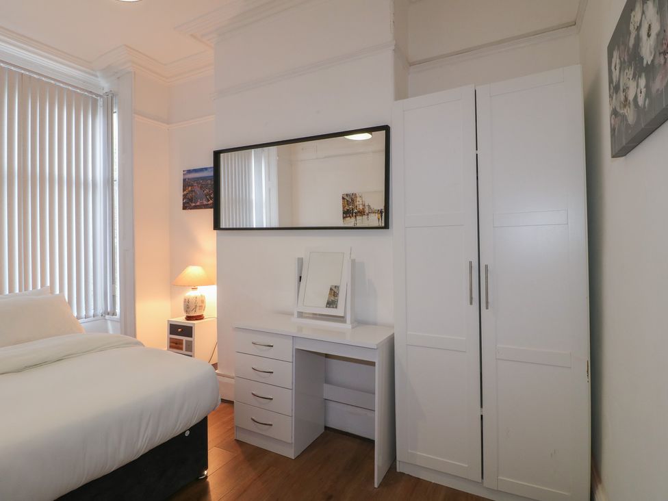 A bedroom with a bed and a desk at 2 Evington Road