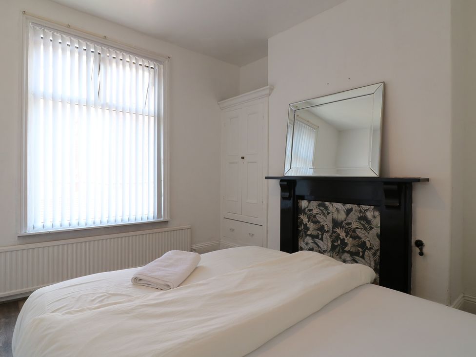 A bedroom with a bed and a window at 2 Evington Road