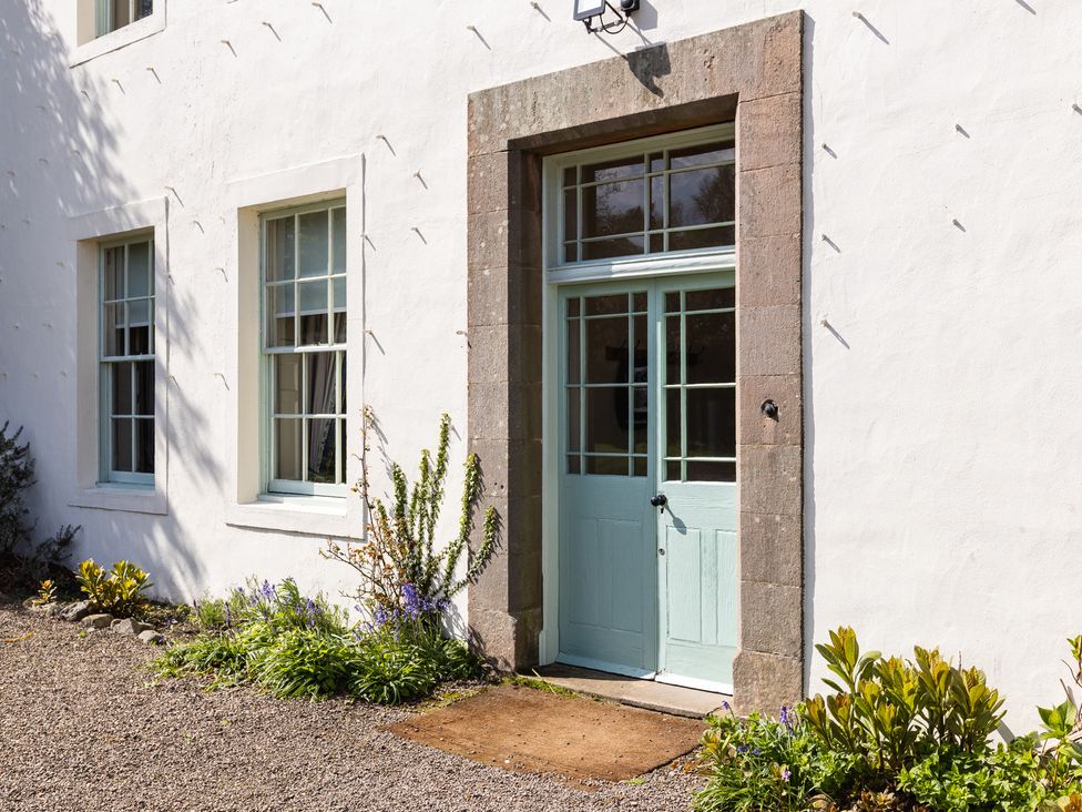 A door with windows and plants at Cheviot Manor in Akeld near Wooler