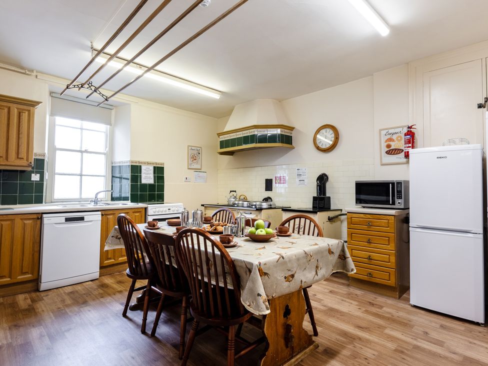 A kitchen with a table and chairs at Cheviot Manor near Wooler
