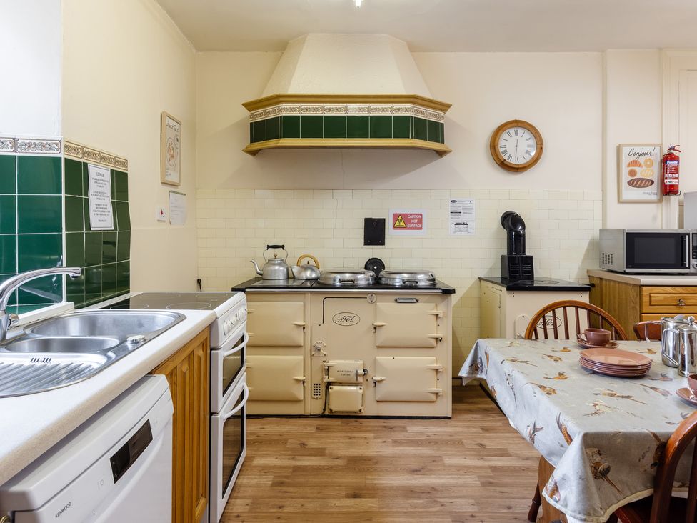 A kitchen with a stove and table at Cheviot Manor Akeld near Wooler