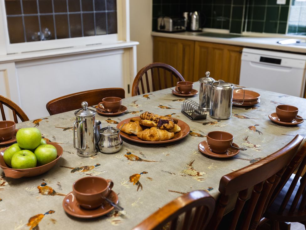 A kitchen with a table set for breakfast at Cheviot Manor in Akeld near Wooler