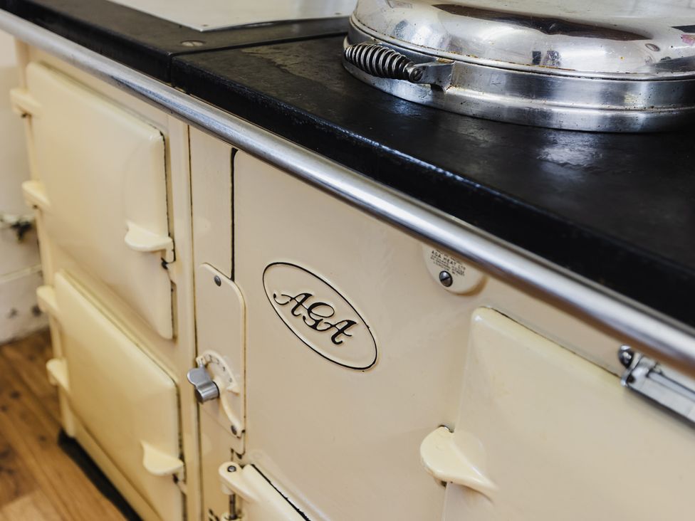 An AGA cooker with a black cooking surface in the kitchen at Cheviot Manor, Akeld near Wooler