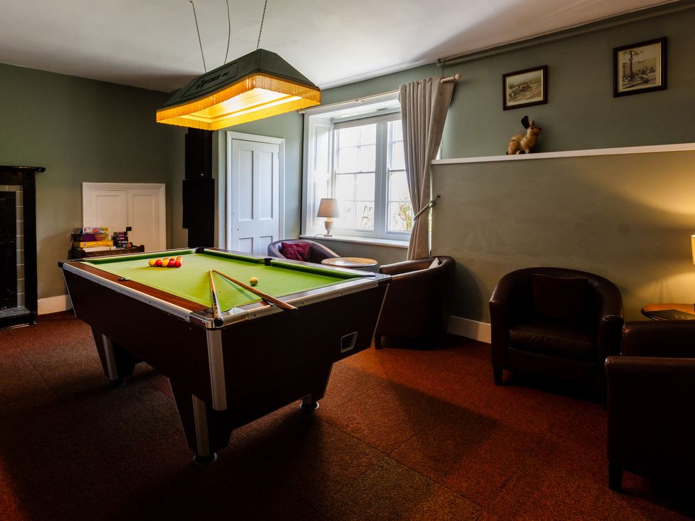 A snug with a pool table and armchairs at Cheviot Manor Akeld near Wooler