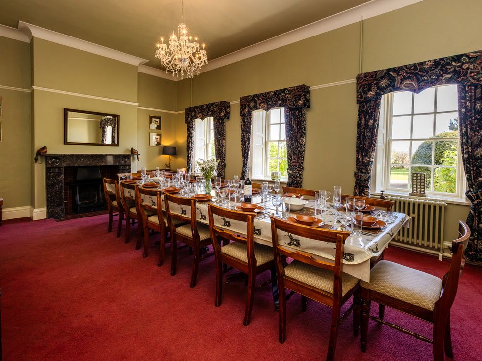 A dining room with a large table set for a meal at Cheviot Manor in Akeld near Wooler