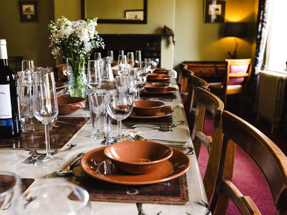 A dining room table set with plates and glasses at Cheviot Manor in Akeld near Wooler