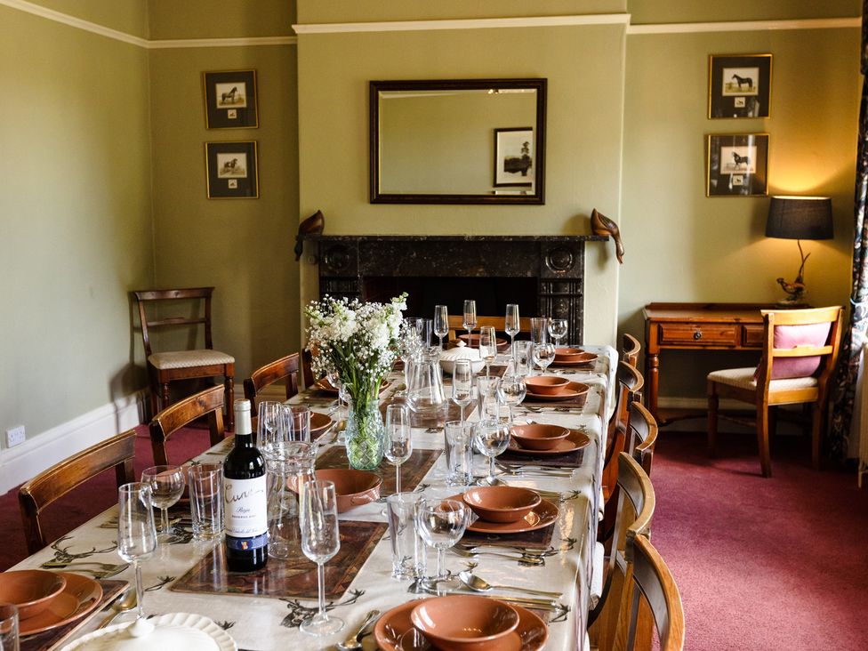 A dining room with a large table set for a meal at Cheviot Manor Akeld near Wooler