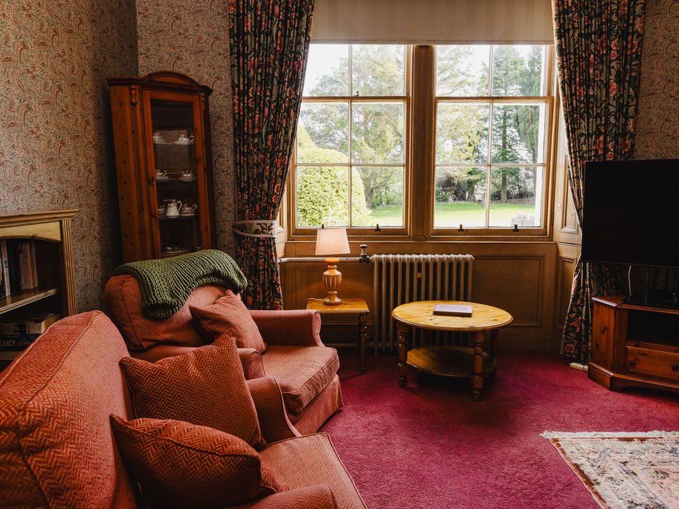 A living room with a sofa and armchair at Cheviot Manor in Akeld near Wooler