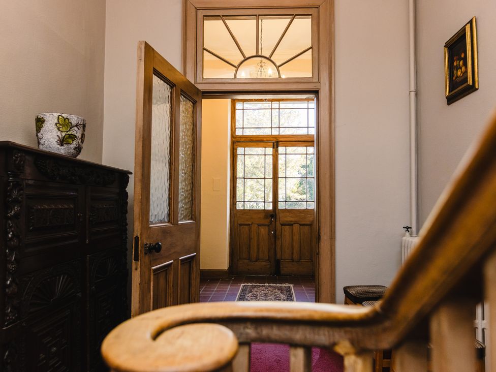 A hallway with a front door and a vase at Cheviot Manor Akeld near Wooler
