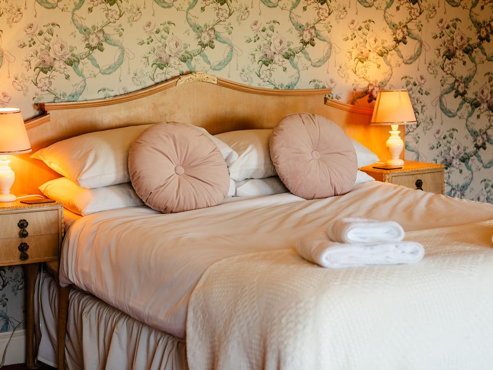 A bedroom with a bed and bedside tables at Cheviot Manor Akeld near Wooler