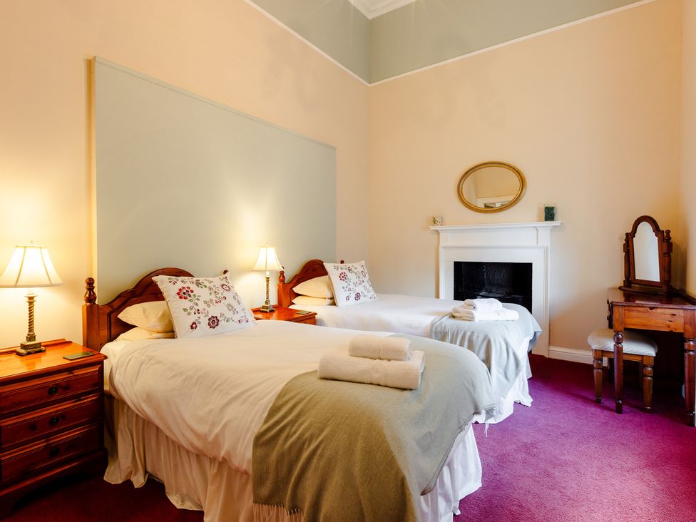 A bedroom with two beds and a dresser at Cheviot Manor Akeld near Wooler
