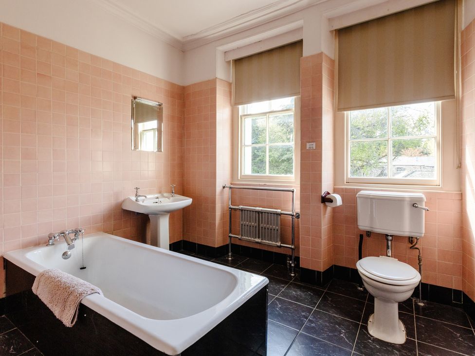 A bathroom with bathtub sink and toilet at Cheviot Manor in Akeld near Wooler