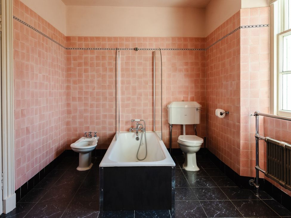 A bathroom with a bathtub, toilet, and bidet at Cheviot Manor in Akeld near Wooler