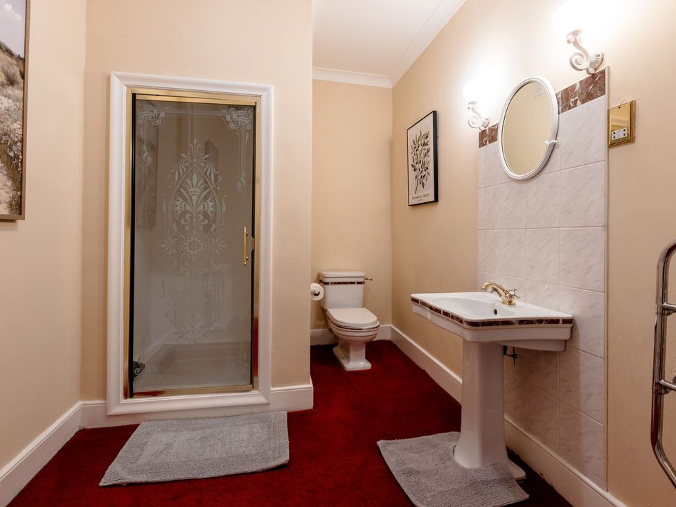 A bathroom with a shower, toilet and sink at Cheviot Manor Akeld near Wooler