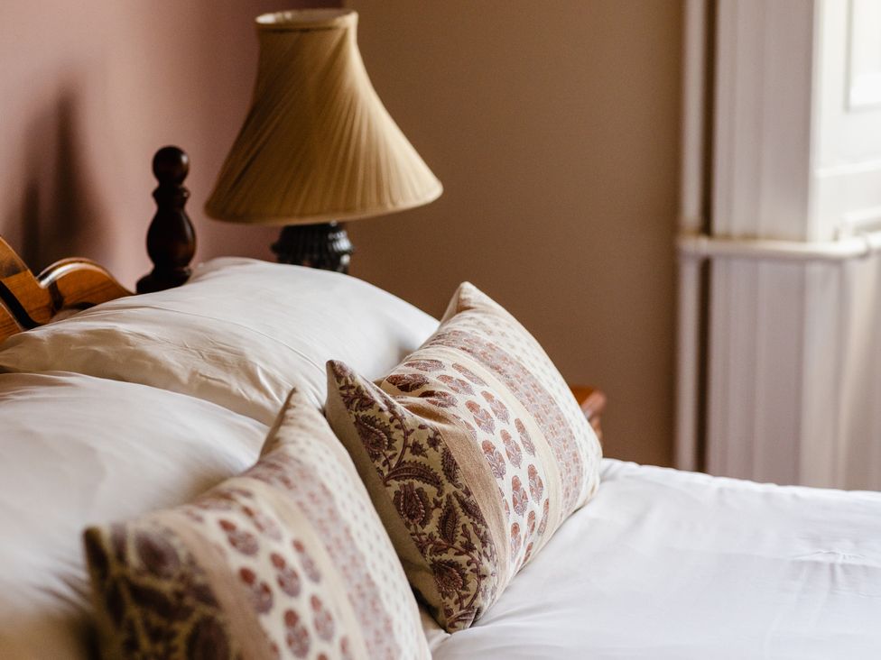 A bedroom with a bed and lampshade at Cheviot Manor in Akeld near Wooler