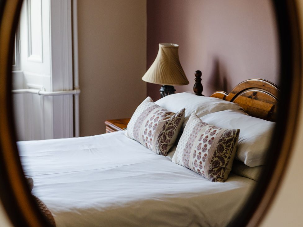 A bedroom with a bed and lamp at Cheviot Manor Akeld near Wooler