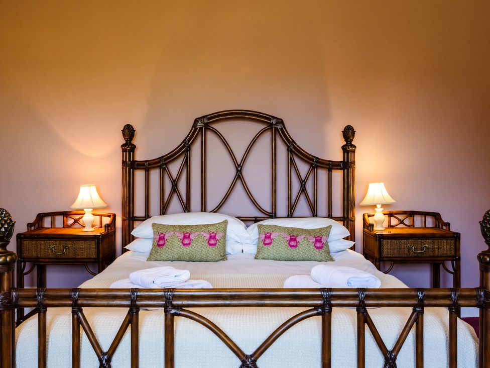 A bedroom with a bed and bedside tables at Cheviot Manor Akeld near Wooler