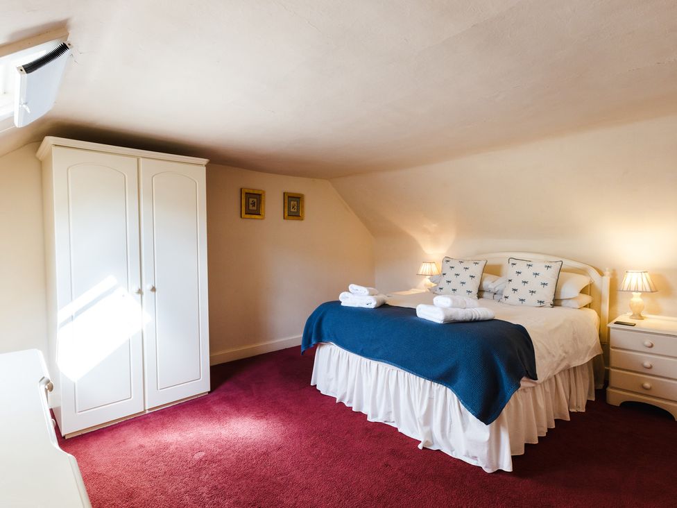 A bedroom with a bed and wardrobe at Cheviot Manor in Akeld near Wooler