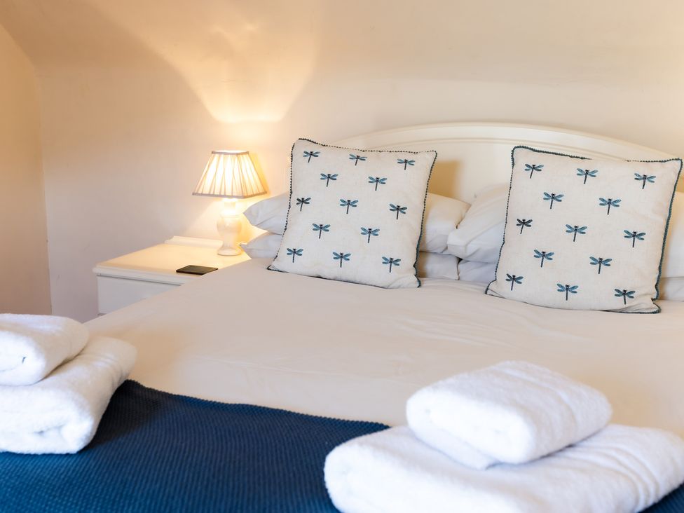 A bedroom with a bed and pillows at Cheviot Manor Akeld near Wooler