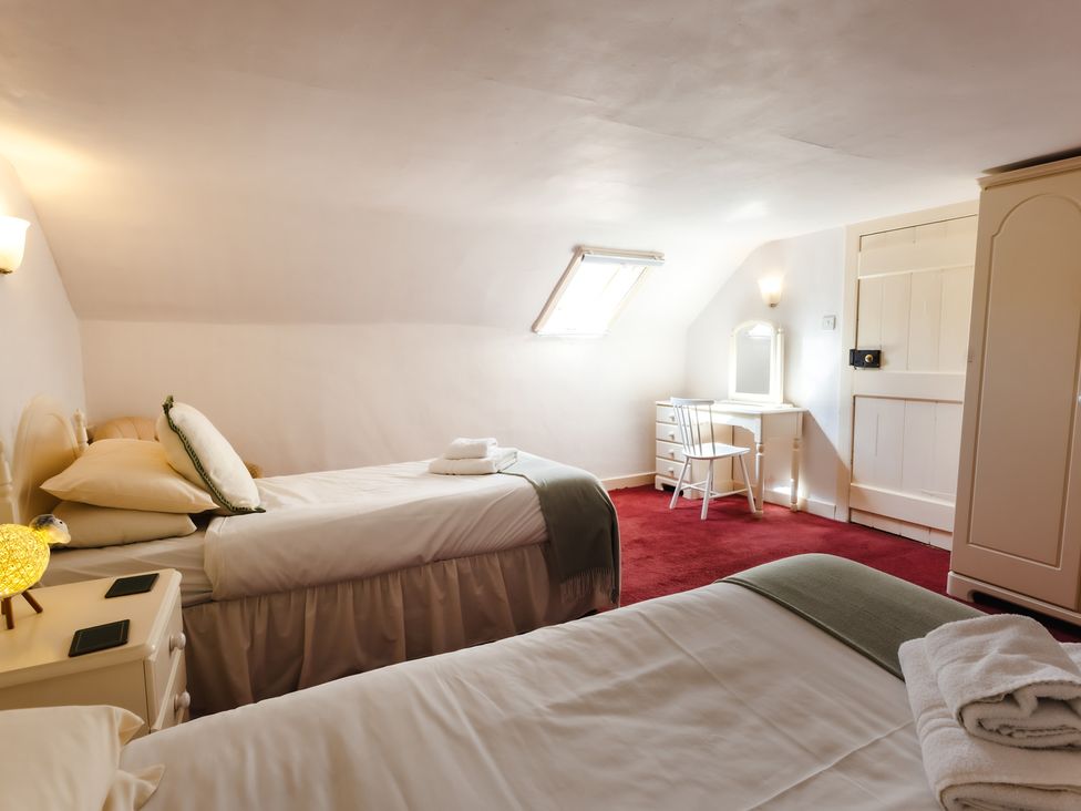 A bedroom with two beds and a vanity at Cheviot Manor in Akeld near Wooler