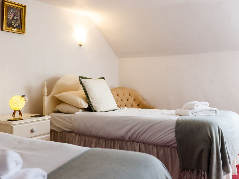 A bedroom with beds and a lamp at Cheviot Manor Akeld near Wooler