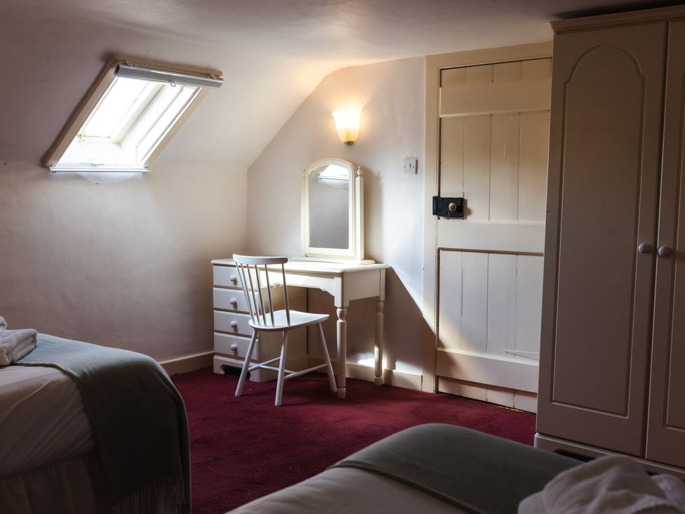 A bedroom with a vanity table and window at Cheviot Manor near Wooler