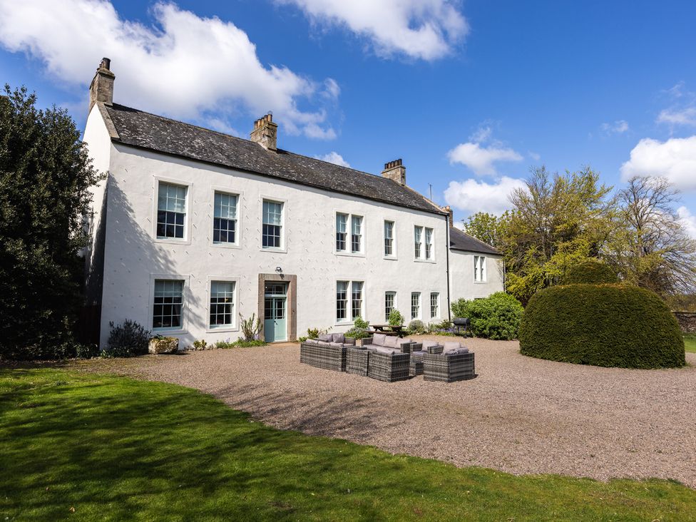 A house with windows and a garden at Cheviot Manor in Akeld near Wooler