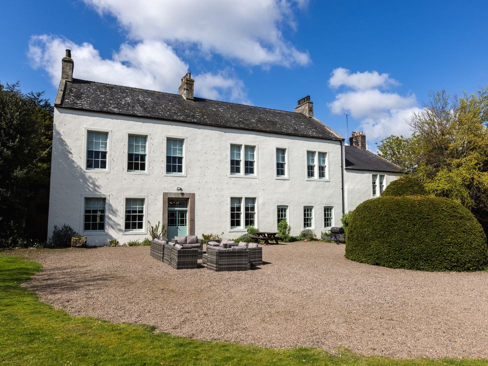 An outdoor seating area in front of a house at Cheviot Manor Akeld near Wooler
