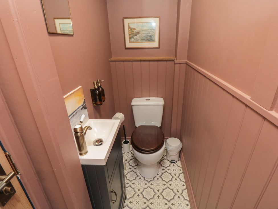 A bathroom with a toilet and sink at Sunny Side Runswick Bay