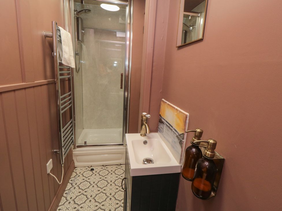 A bathroom with a shower and sink at Sunny Side in Runswick Bay