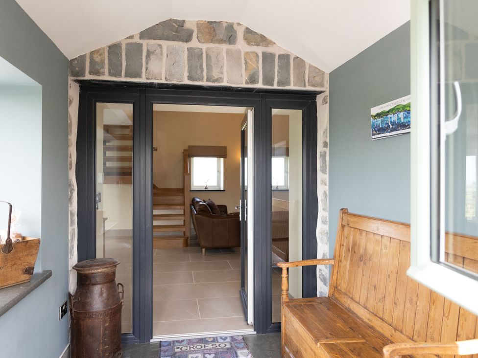 An entryway with a bench and stairs at Golygfa Cwrt in Talybont