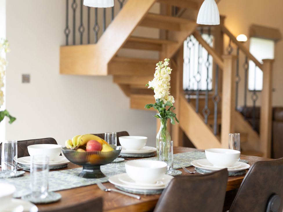 A dining room with a table set for a meal at Golygfa Cwrt in Talybont