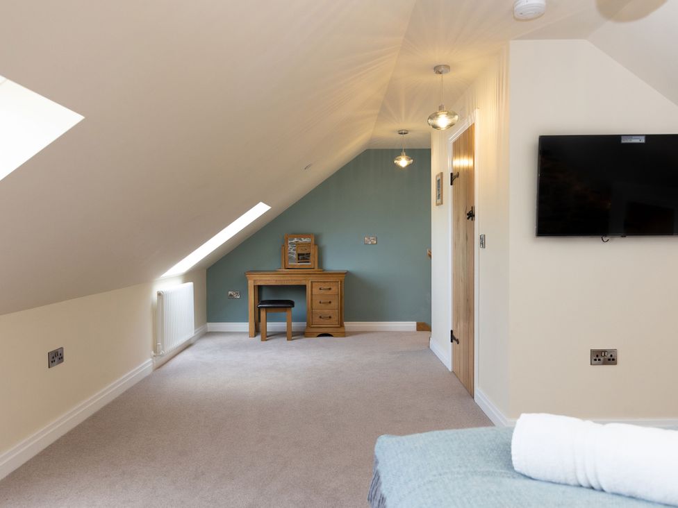 A bedroom with a desk and chair at Golygfa Cwrt in Talybont