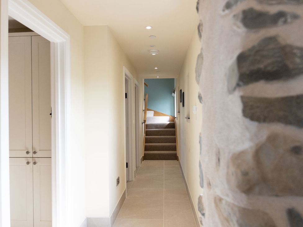 A hallway with a staircase leading up at Golygfa Cwrt in Talybont