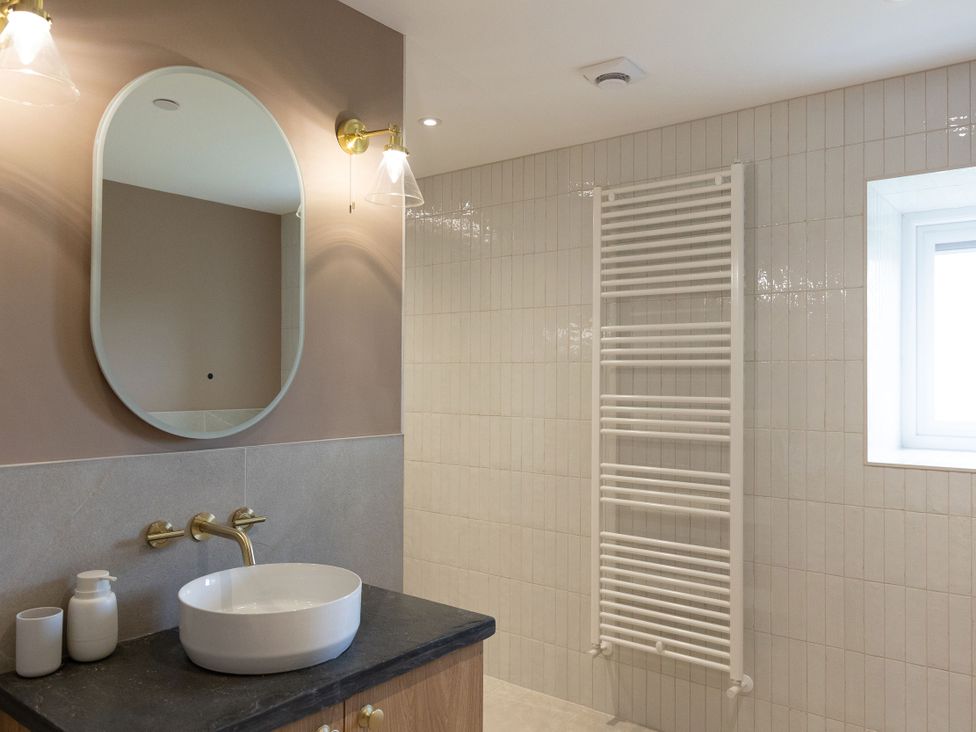 A bathroom featuring a sink and a towel radiator at Golygfa Cwrt in Talybont