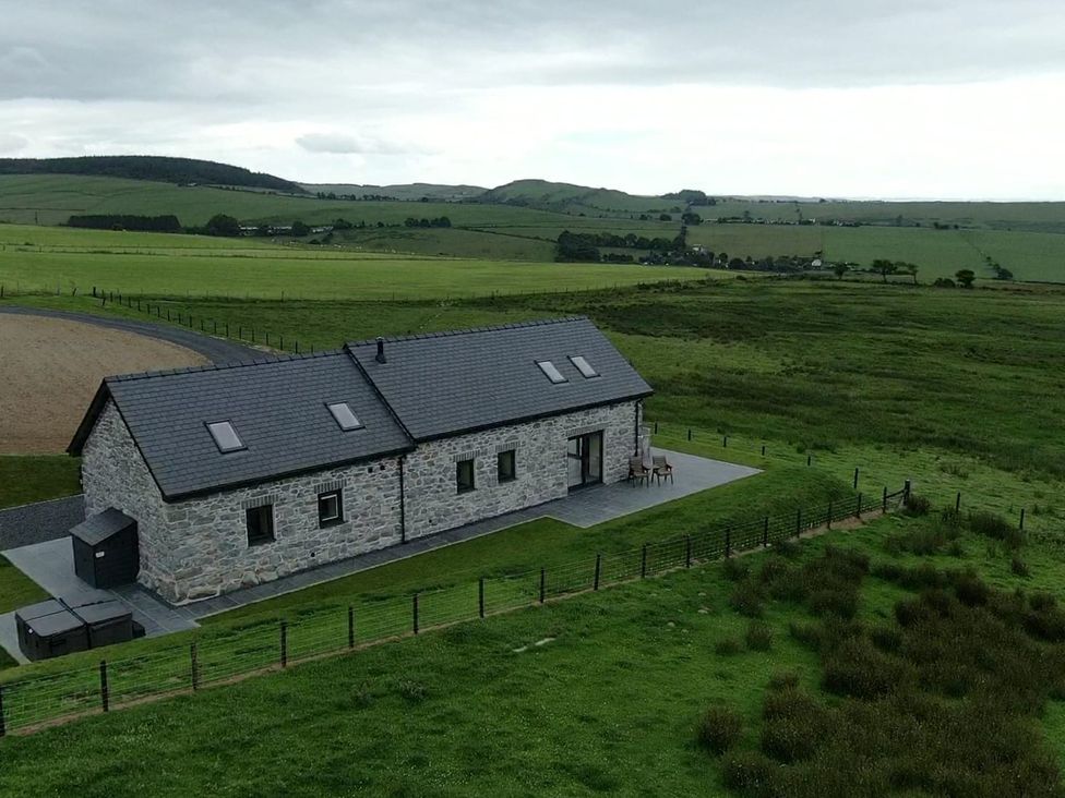 A house with a patio area and surrounding landscape at Golygfa Cwrt Talybont