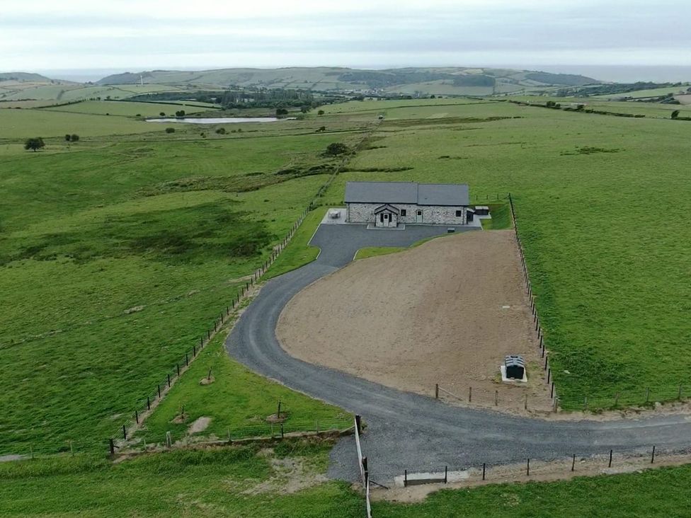 An outdoor view of a house with a paddock and surrounding fields at Golygfa Cwrt Talybont