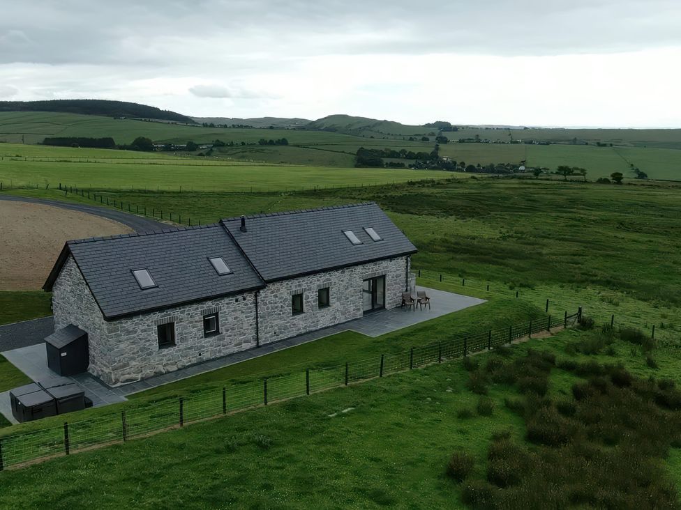 A house with a patio and field view at Golygfa Cwrt near Bontgoch and Penrhyncoch
