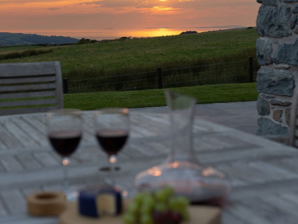 An outdoor dining setup with wine and cheese at Golygfa Cwrt near Bontgoch and Penrhyncoch